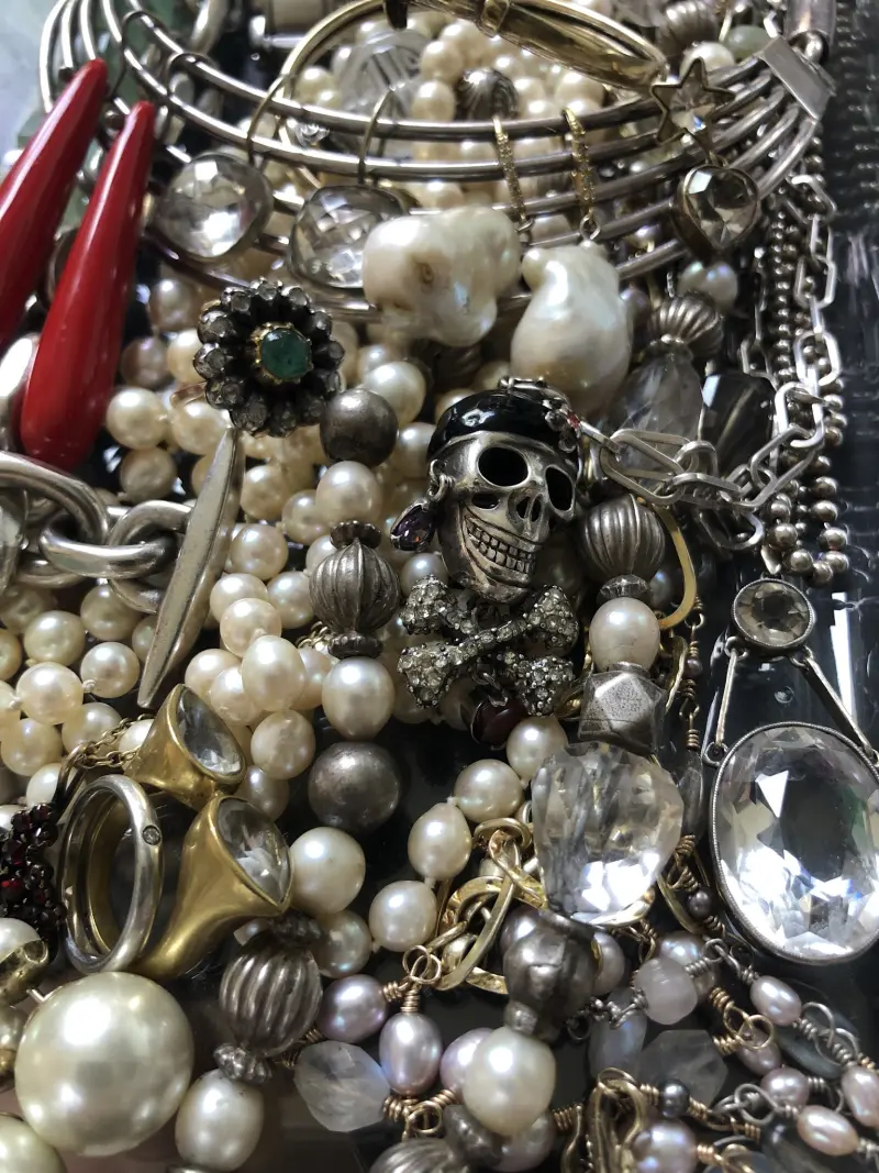 Pile of vintage costume jewellery including a silver skull brooch at Uuli's curiosities shop